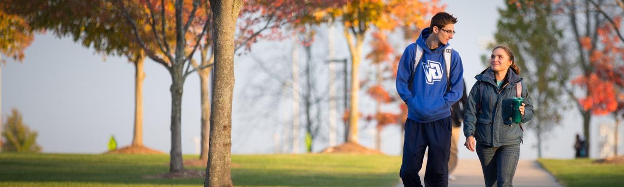 Two students walking together on the Allendale GVSU Campus